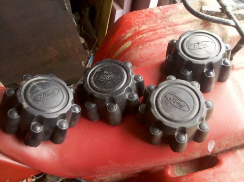 2003 Ford F-250 - Set of four black hubcaps for a 2003 Ford F-250, each the Ford logo.