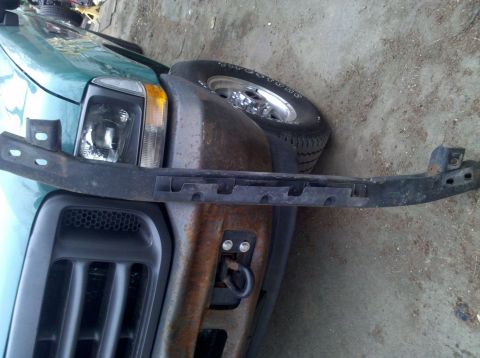 2003 Ford F-250 - Front view of a green truck, likely a 2003 Ford F-250, with a black bumper bracket and visible grille.