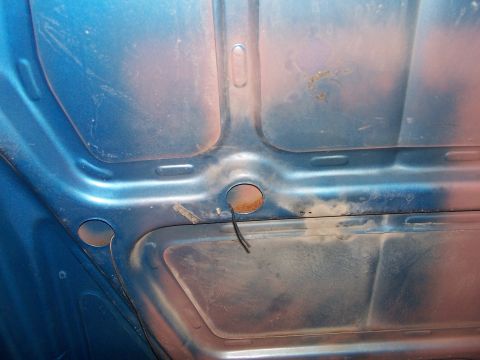 1973 Ford Ranchero - The underside of a blue hood shows some rust and exposed wiring, with a Supermotors.net watermark.