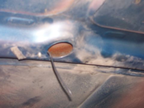 1973 Ford Ranchero - A close-up view of the underside of a vehicle's hood, showing a circular opening and a wire.