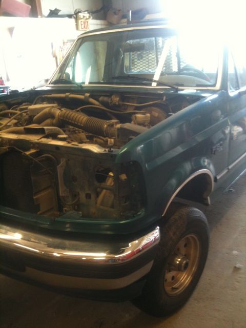 1993 Ford Bronco - Front view of a 1993 Ford Bronco with its hood open, revealing the engine compartment.