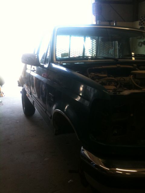 1993 Ford Bronco - This Ford F-Series truck is parked indoors with its hood up, showing the engine bay.