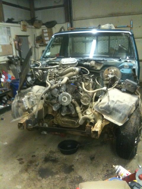 1993 Ford Bronco - Disassembled truck engine bay with exposed engine and chassis parts, indicating repair or parts harvesting.