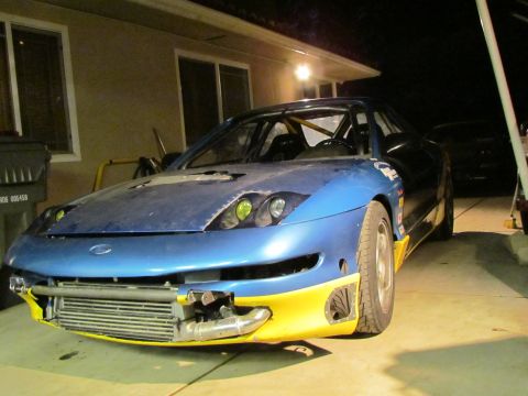 1995 Ford Probe - This modified coupe features a prominent intercooler and racing seats, suggesting it's built for performance.