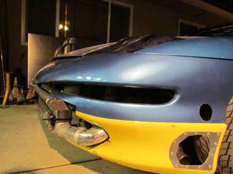 1995 Ford Probe - Customized car front end with intercooler piping visible, undergoing modifications.