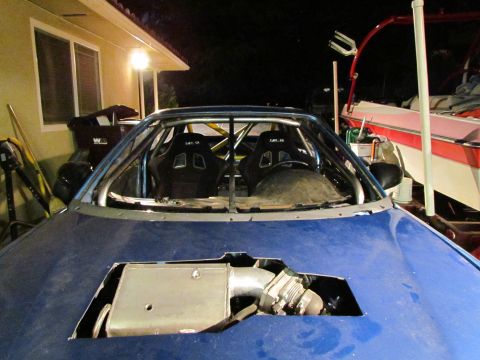 1995 Ford Probe - Modified blue car with racing seats and roll cage, hood removed to expose engine parts.
