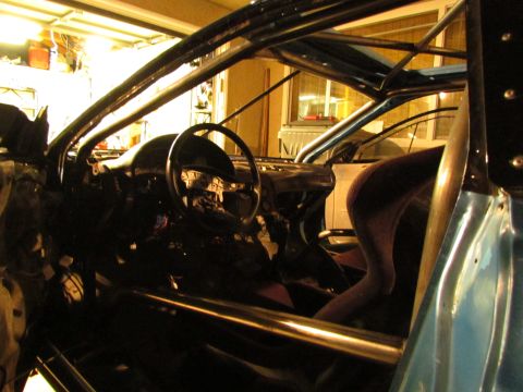 1995 Ford Probe - The interior of a car is shown with a prominent roll cage and racing seat, suggesting a modified vehicle.