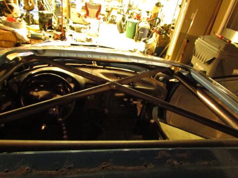 1995 Ford Probe - Interior view of a blue car with a prominent black roll cage installed.