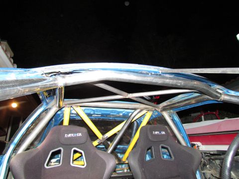 1995 Ford Probe - The interior of a blue car shows racing seats and a custom roll cage, with no visible year identification.