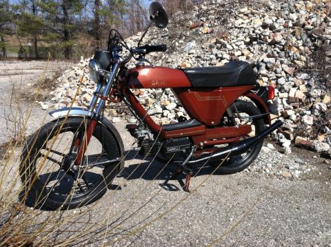 1981 Garelli Rally Sport - A red moped sits on a gravel lot with a pile of rubble behind it.