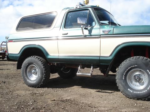 1979 Ford Bronco - Side view of a lifted Ford Bronco with two-tone paint and chrome trim.