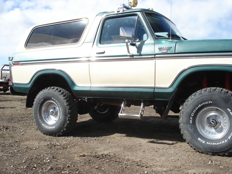 Green and cream Ford Bronco with aftermarket wheels and tires