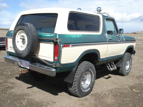 1979 Ford Bronco - Rear view of a two-tone green and cream Ford Bronco with a spare tire mounted externally.