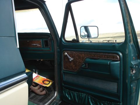 1979 Ford Bronco - Interior view of a 1979 Ford Bronco, highlighting the door panel and dashboard details.