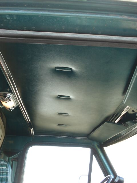 1979 Ford Bronco - Interior view of a green upholstered ceiling with tufting and a grab handle, likely from a 1978 vehicle.