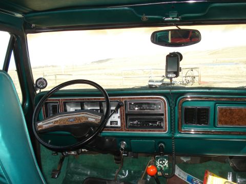 1979 Ford Bronco - Interior view of a 1979 Ford Bronco, wood grain trim and a GPS unit.