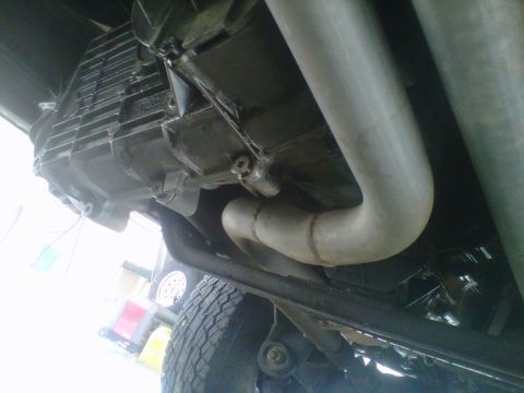 1994 Ford F-150 - The underside of a vehicle is visible, the transmission and exhaust system.