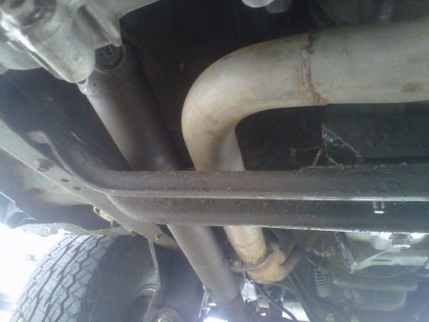 1994 Ford F-150 - Undercarriage view of a truck's exhaust system and drivetrain components.
