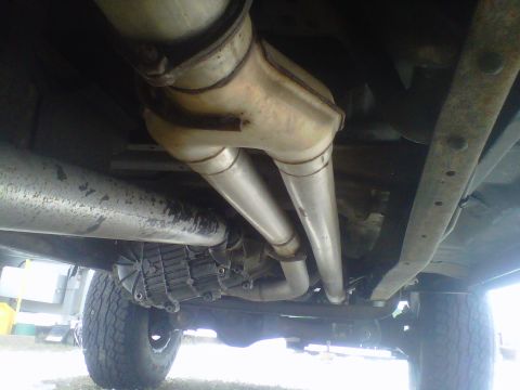 1994 Ford F-150 - This photo shows the undercarriage of a truck, focusing on the exhaust and transmission components.