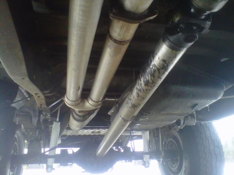 1994 Ford F-150 - The underside of a truck is visible, focusing on the exhaust system and drivetrain components.