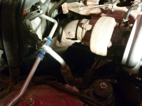 1997 Dodge 2500 - Engine bay view showing a turbocharger and metal pipes with blue clamps.
