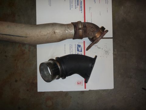 1997 Dodge 2500 - Two automotive parts, an exhaust pipe and an intake tube, are laid out on shipping boxes.