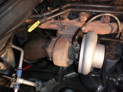 1997 Dodge 2500 - Engine bay detail showing a turbocharger, exhaust manifold, and transmission fluid dipstick.