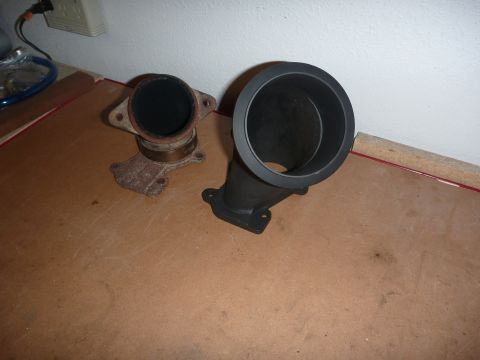 1997 Dodge 2500 - Two exhaust pipe parts are shown on a flat surface, one appearing rusted and the other painted black.