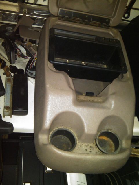 1993 Ford Bronco - Center console part with two cup holders and open storage compartment, possibly from a Ford Bronco.