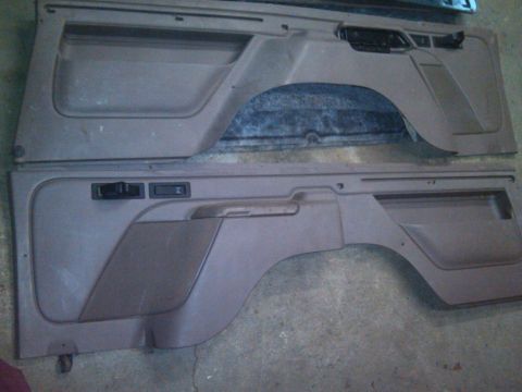 1993 Ford Bronco - Two interior door panels are laid out, likely for repair or replacement.