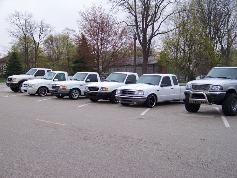 1987 Ford Ranger - A lineup of Ford Ranger trucks, including a lifted silver model, are parked in an outdoor lot.