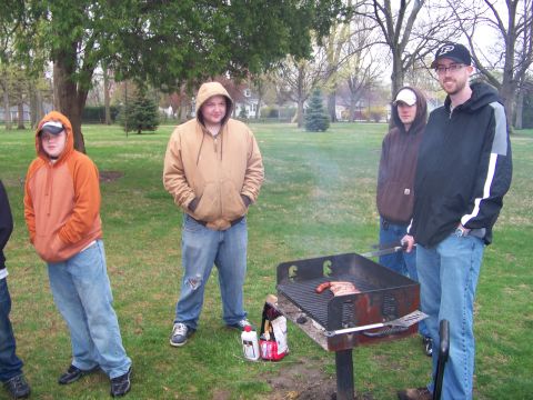 1987 Ford Ranger - A group of friends gather in a park for a barbecue, with food cooking on the grill.
