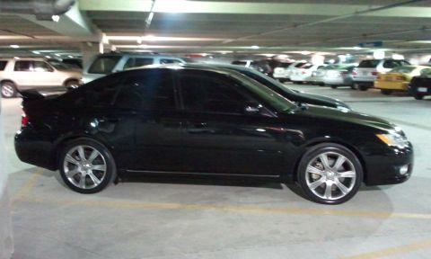 2008 Subaru Legacy - Side view of a black 2008 Subaru Legacy sedan parked in a garage.