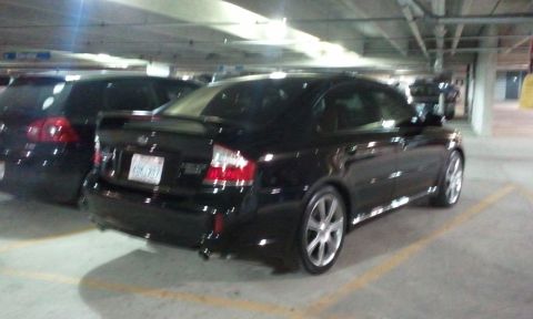 2008 Subaru Legacy - Rear view of a black Subaru Legacy sedan in a parking garage.