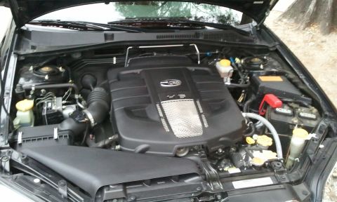 2008 Subaru Legacy - The engine bay of a 2008 Subaru Legacy is captured from a high angle, revealing the V3 engine cover and surrounding parts.