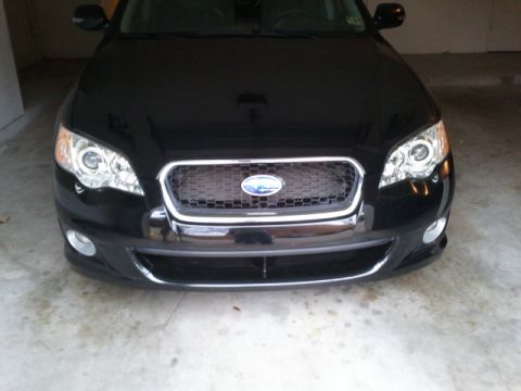 2008 Subaru Legacy - Front view of a black 2008 Subaru Legacy, showing the grille and headlights.