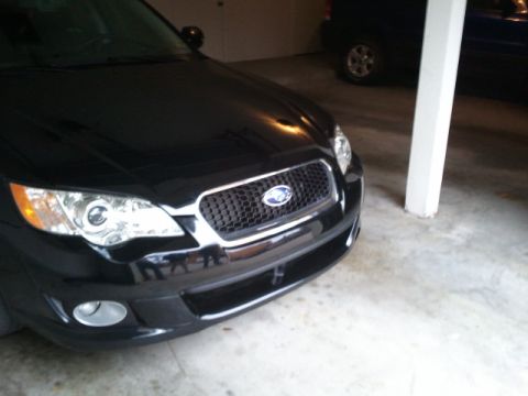 2008 Subaru Legacy - A black Subaru sedan is parked in a garage, with another vehicle visible behind it.