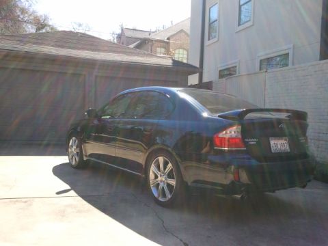 2008 Subaru Legacy - Rear view of a dark 2008 Subaru Legacy sedan parked in a driveway.