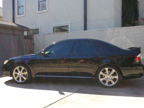 2008 Subaru Legacy - Side view of a black sedan with a spoiler on the trunk.