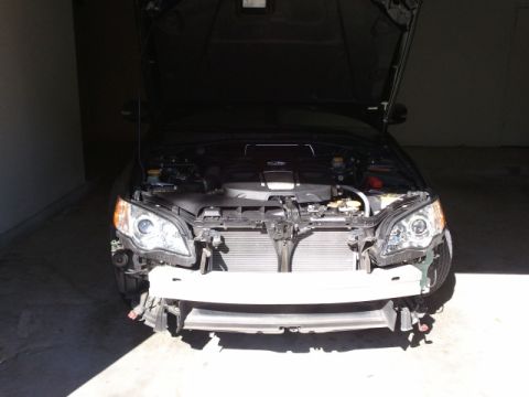 2008 Subaru Legacy - This Subaru Legacy, likely from the mid-2000s, is undergoing front-end repairs with its bumper removed.