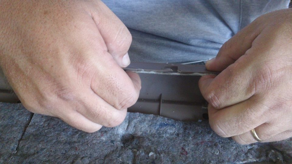 hands pulling trim piece from car interior