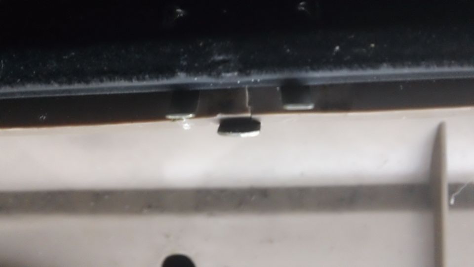 1994 Ford Bronco door latch mechanism, metal and plastic components, some dirt visible
