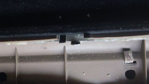 1994 Ford Bronco - Close-up view of a clip securing an interior trim panel, likely for door repair.