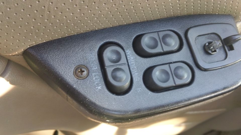 Door panel with window and lock controls. Has a SuperMotors logo at the bottom