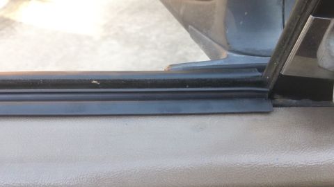1994 Ford Bronco - Door seal detail on a vehicle interior, showing the rubber weatherstripping and surrounding panels.