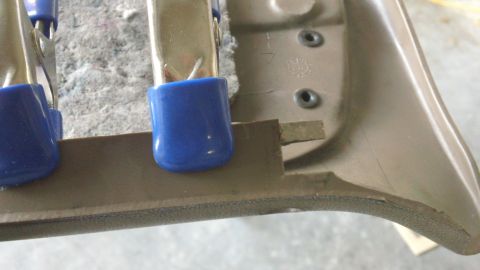 1994 Ford Bronco - Clamps holding an interior trim panel during repair work.