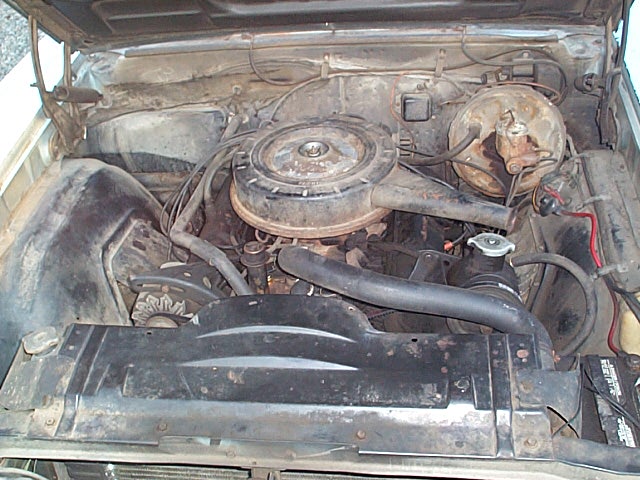 Engine bay view showing air cleaner, radiator, and battery