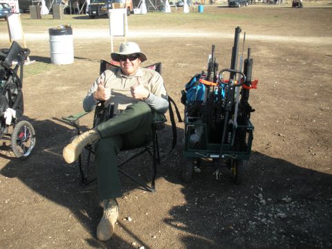 1996 Ford Bronco - A man relaxes outdoors with his firearms organized in a cart.