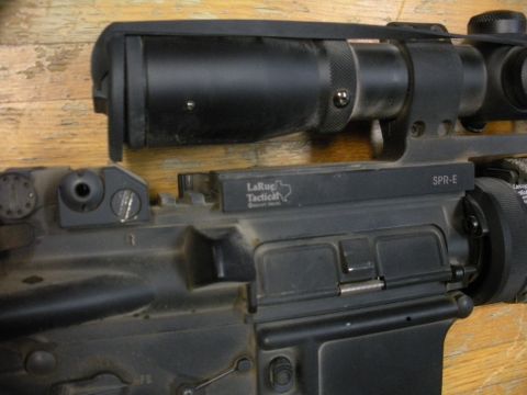 1996 Ford Bronco - A tactical rifle with a scope is shown in detail, markings from LaRue Tactical and SPR-E.