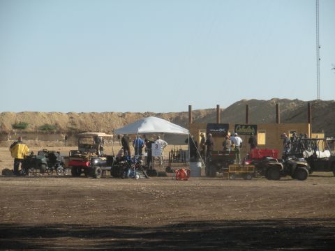 1996 Ford Bronco - People and ATVs at an outdoor shooting range with a building and berm in the background.